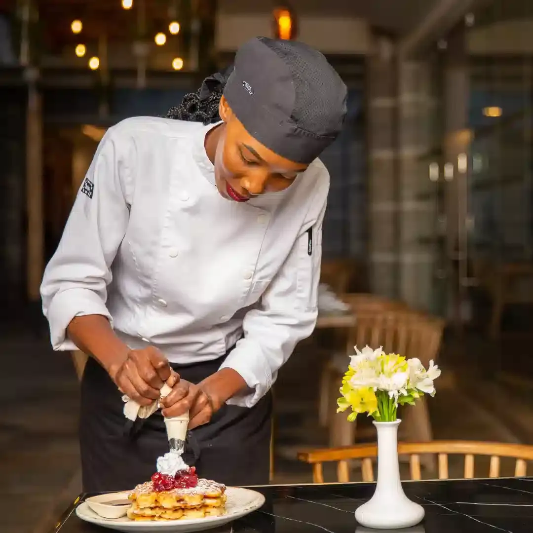 Chef de Partie preparing gourmet dishes in hotel kitchen