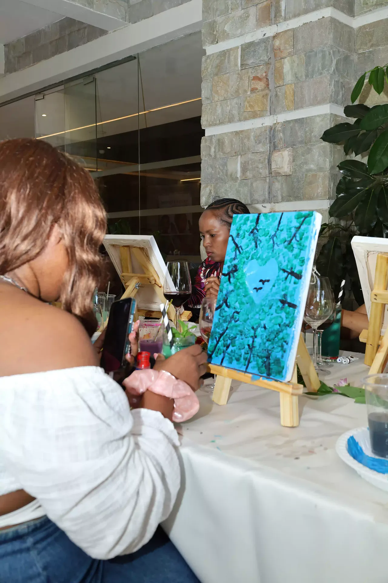 Friends enjoying Sip and Paint session at Alba Hotel