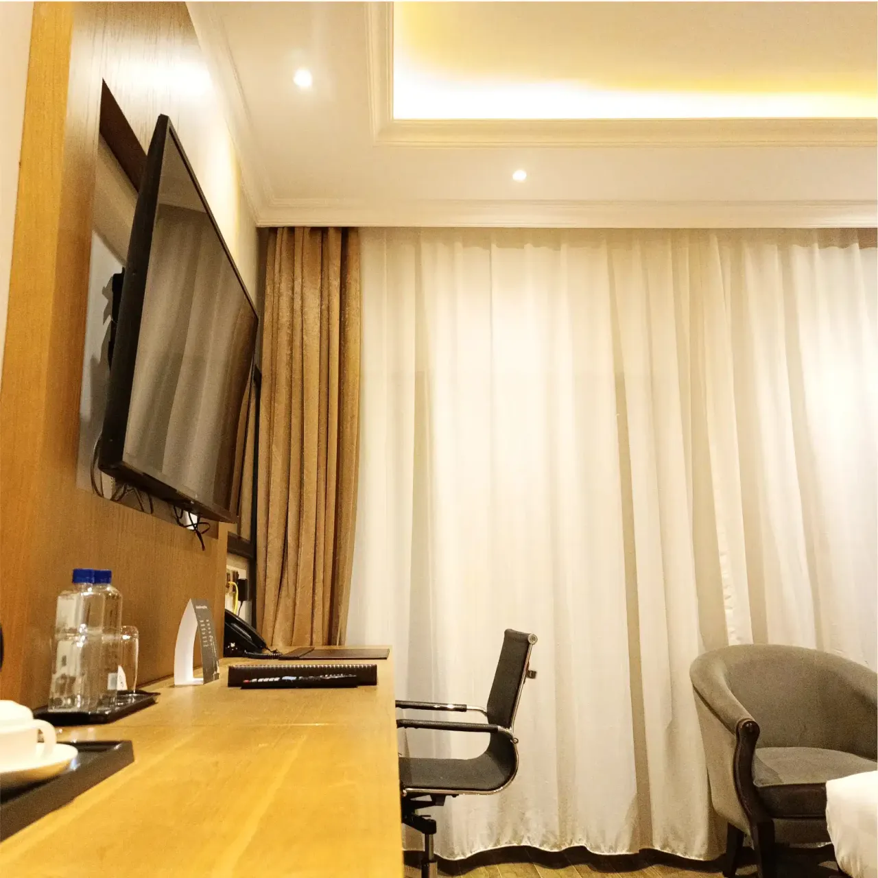 Deluxe Room - cozy seating area with natural lighting
